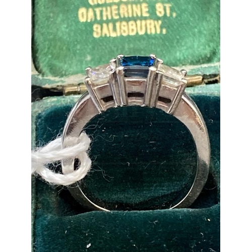 519 - Jewellery: White metal ring set with three princess cut diamonds, centre diamond blue in colour, est... 