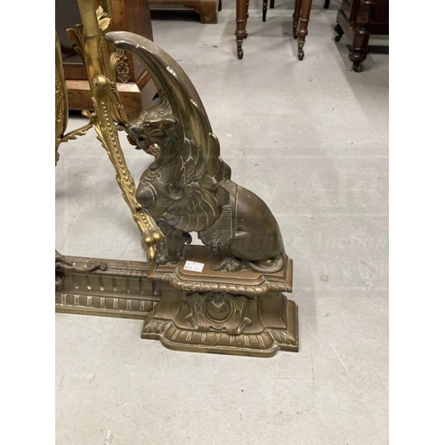 97 - 19th cent. French adjustable cast brass Griffin fireplace chevets and fender set. Height 17ins. x 46... 