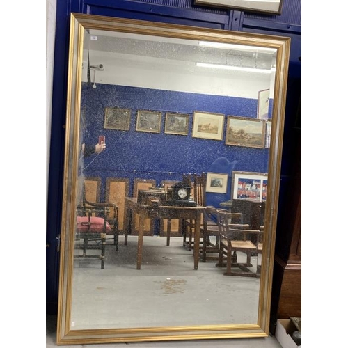 150 - 20th cent. Mirror, bevelled glass plate with gilt and silvered frame. 54½ins. x 77½ins.