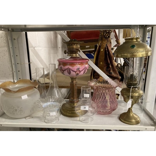 28 - Lighting: Brass round base oil lamp, round column, pink glass reservoir with painted swags and pink ... 