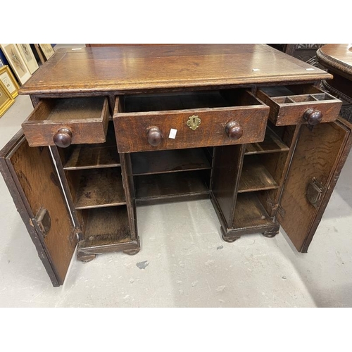 103 - 19th cent. Oak kneehole desk, three drawers across the top, with a door either side revealing shelve... 