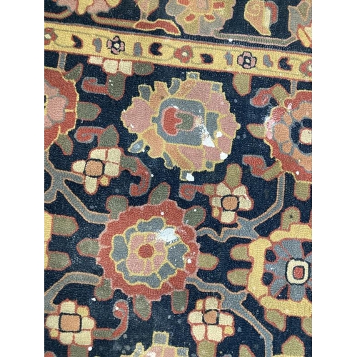 38 - Carpets & Rugs: Oriental woollen carpet black and navy blue ground, two borders and central panel of... 