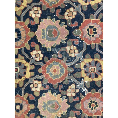 38 - Carpets & Rugs: Oriental woollen carpet black and navy blue ground, two borders and central panel of... 