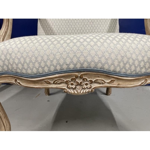 53 - 20th cent. French style open arm chair with blue upholstery and piping over a limed finish.