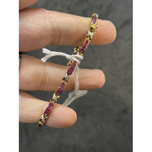 575 - Jewellery: Yellow metal bracelet set with forty-four calibre set rubies, estimated weight of (44) 2.... 