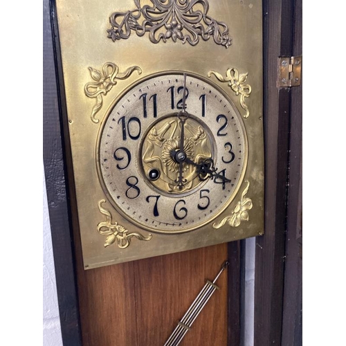 120 - Clocks: Art Nouveau regulator with brass face and stylised spandrels. 43ins.