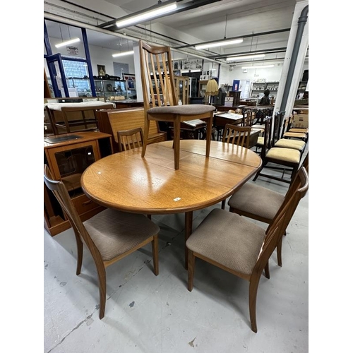 28 - Mid 20th cent. G-Plan teak effect circular table with six chairs (chairs upholstery does not conform... 