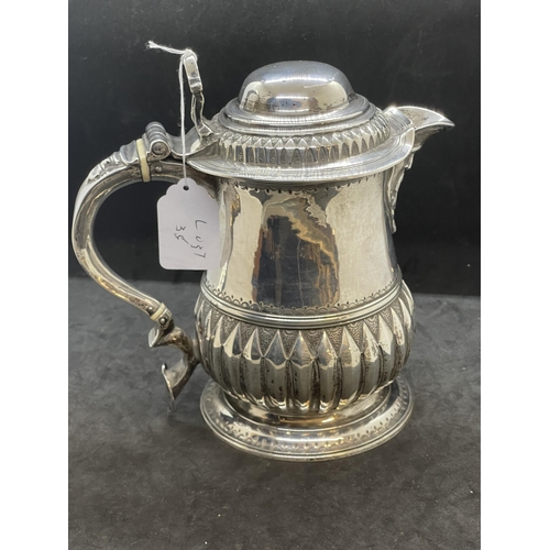 394 - Georgian Hallmarked Silver: Lidded jug with reed pattern handle, lid with scroll handle, ivory insul... 