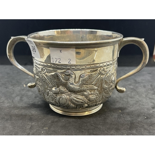 396 - Silver & Plated Ware: George II white metal two handled loving cup with embossed swan decoration, ha... 