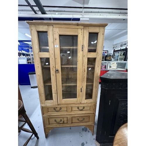 43 - 20th cent. Stripped pine display unit, two opening doors over two drawers. Approx. 67ins. x 35ins. x... 