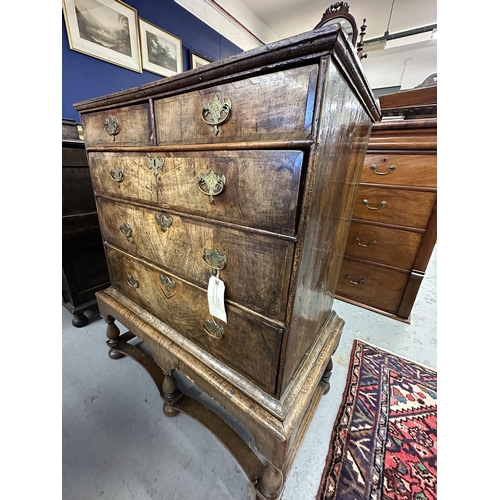 106 - William and Mary/Queen Anne walnut two over three chest of drawers on stand, the drawers with matche... 