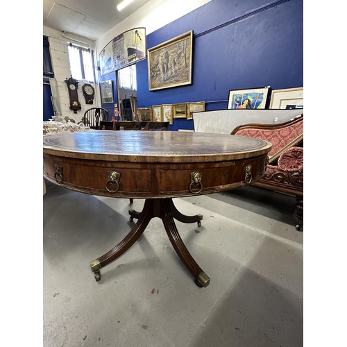 110 - 19th cent. Rosewood drum table with eight drawers, brass lion head handles and leather top on all co... 