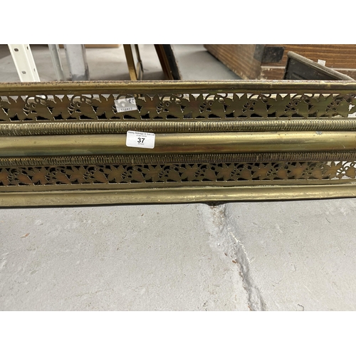 37 - Two brass fire fenders, the larger 47ins. x 7½ins. The smaller 31½ins. x 6ins. Both with piercework ... 