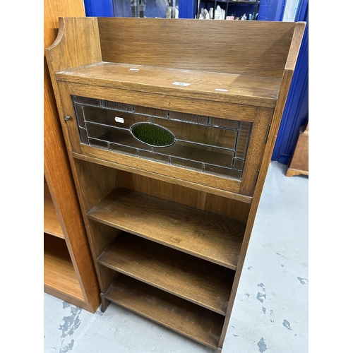 51 - Oak narrow bookcase, stained glass cupboard with shelves below, Derry & Thomas, Kensington label... 