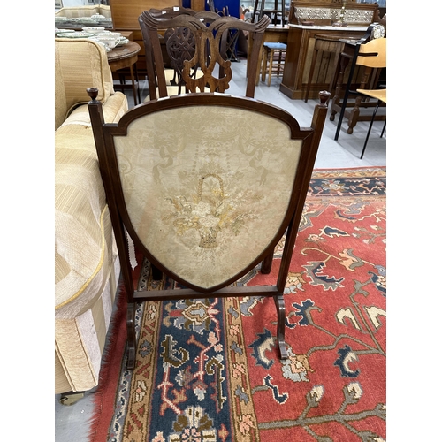 54 - 19th cent. Mahogany fire screen with needlepoint floral design within a shield.