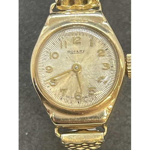 558 - 9ct gold rotary round silver coloured dial with Arabic numerals on a gold plated expanding bracelet.... 