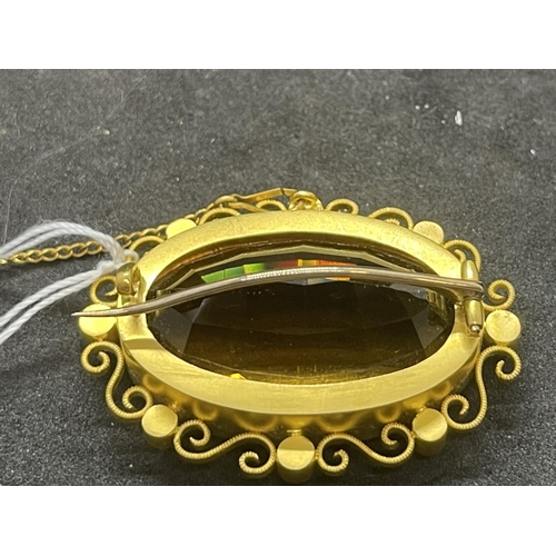 570 - Yellow metal brooch set with an oval citrine with a scroll and pearl surround, tests as 18ct gold. W... 