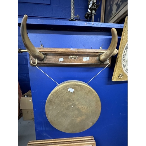 14 - Metalware: Brass dinner gong supported on oak and cow horn plinth.