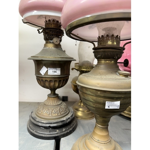 196 - Lighting: 19th/20th cent. Oil lamps with brass urn-shaped reservoirs and stands, two with shades, al... 