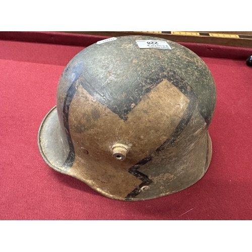 228 - Militaria: German infantry helmet with later paint together with zinc water bottle.