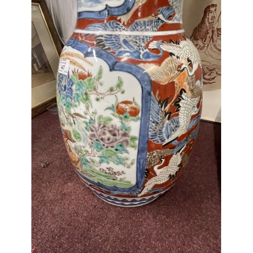 447 - Ceramics: 19th cent. Imari floor vase bulbous base, slim neck and flared rim with birds, floral pane... 