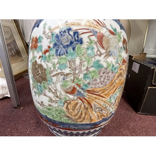 447 - Ceramics: 19th cent. Imari floor vase bulbous base, slim neck and flared rim with birds, floral pane... 