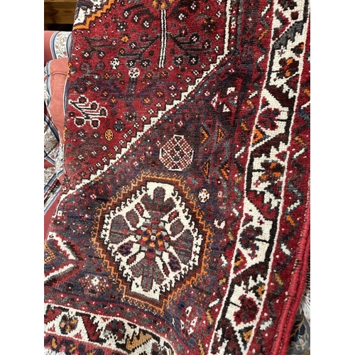 46 - Carpets & Rugs: Modern weave Iranian Shiraz red ground with stylised flowers and trees, medallions t... 