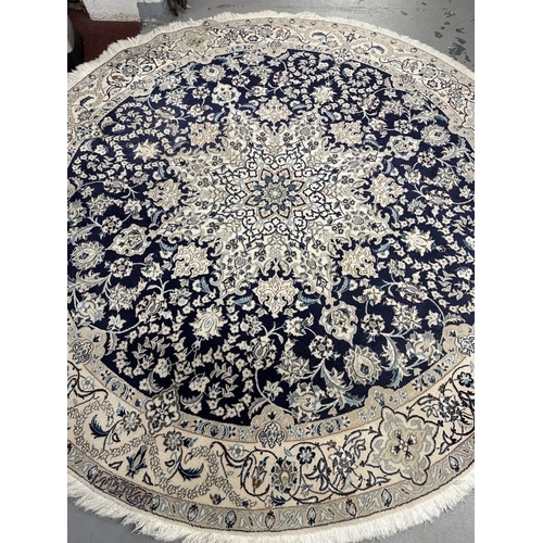 49 - Carpets & Rugs: 20th cent. Circular Persian rug blue ground, floral design in blues, reds and ivorie... 