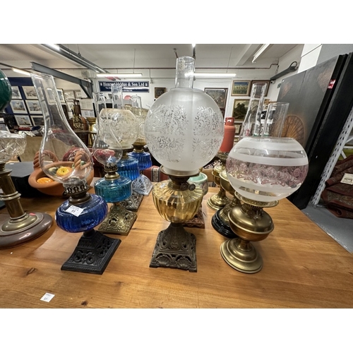 65 - Lighting: / Lighting: / Lighting: 19th cent. Oil lamps with blue glass reservoirs and cast iron base... 