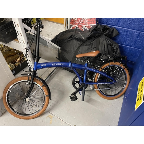 15 - Bicycles:: Raleigh stow-a-way folding bikes, as new in carrying bags plus accessories. (2)... 