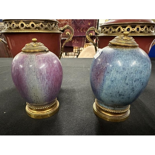 464 - Ceramics: Pair of ormolu mounted ox blood pottery lidded urns together with a pair of Flambe ormolu ... 