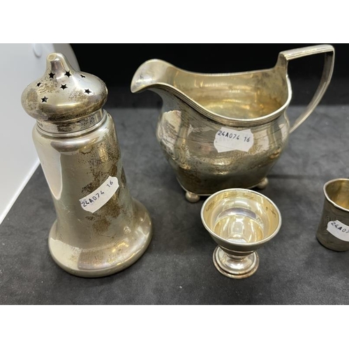 512 - Hallmarked Silver: Cream jug, bud vase, eggcup, shot measure, sugar sifter and pepperpot, various ha... 