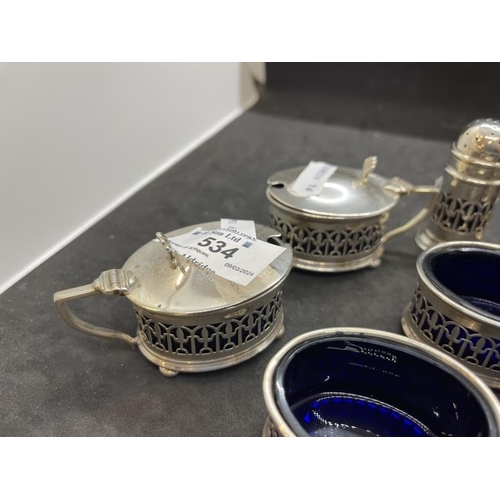 534 - Hallmarked Silver: Condiment set with blue glass liners, various hallmarks. Net weight 6.02oz.... 