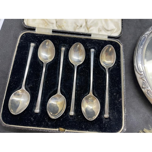 549 - Hallmarked Silver: Hand mirror, Birmingham 1909, together with a cased set of coffee spoons and a cl... 