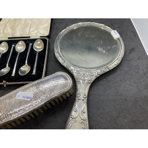 549 - Hallmarked Silver: Hand mirror, Birmingham 1909, together with a cased set of coffee spoons and a cl... 