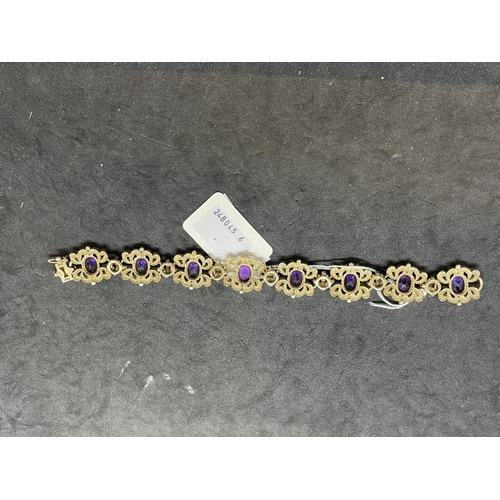 641 - Jewellery: 9ct gold rococo-style bracelet set with amethyst. 20.3cm. Gross weight 32g.