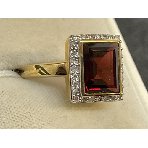 656 - Hallmarked Jewellery: 9ct gold garnet ring, emerald cut surrounded by small diamonds. 5.2g.... 