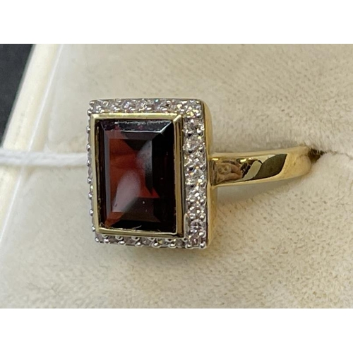 656 - Hallmarked Jewellery: 9ct gold garnet ring, emerald cut surrounded by small diamonds. 5.2g.... 