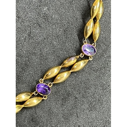 680 - Jewellery: Yellow metal double row bracelet set with six amethysts, unusual moon design safety chain... 