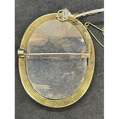 684 - Jewellery: Yellow metal oval brooch 51mm x 39mm set with pietra dura centre having a shot and wire w... 