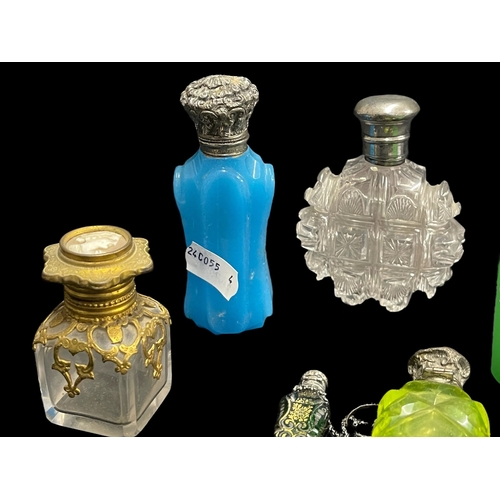 570 - Objects of Vertu: Victorian and later silver and white metal mounted scent bottles together with a p... 