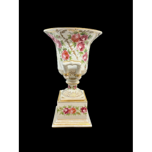 594 - Ceramics: Rose painted Campagna urn with lid. 23cm.