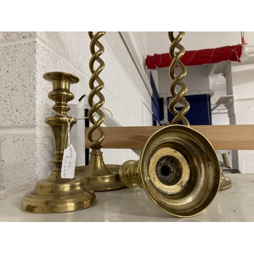 25 - Early 20th cent. Brass candlesticks open twist on cast base, 20ins. Plus a small pair, 7ins.... 