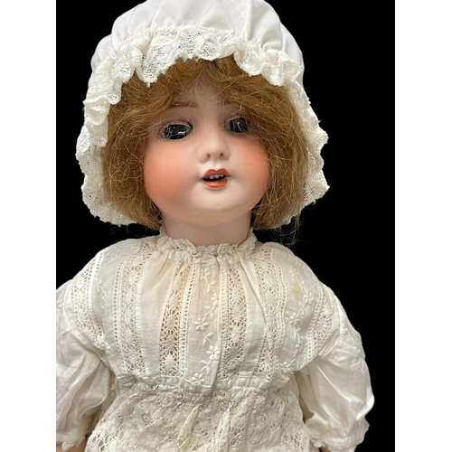 344 - Dolls: French made by S.F.B.J c1910, bisque socket head, weighted brown glass eyes, open mouth, four... 