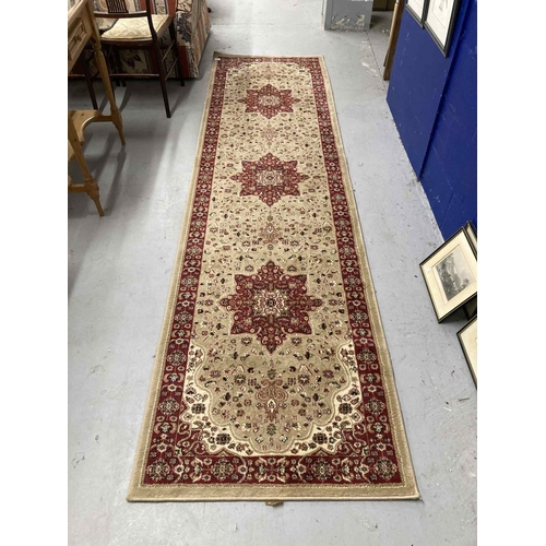 36 - Rugs & Carpets: 20th cent. Persian beige ground runner with three stylised stars. 32ins. x 117ins.... 