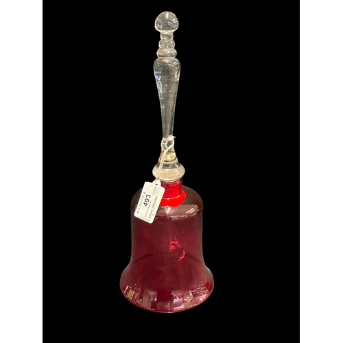 493 - Glass: 20th cent. Ruby glass bell with a clear glass handle topped with a finial, clanger present. 3... 