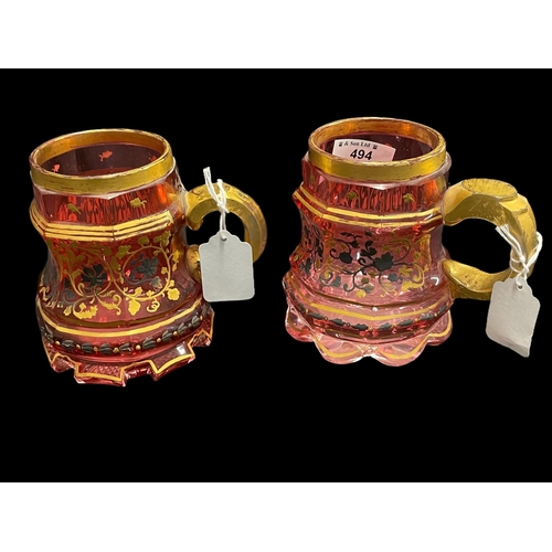 494 - Tankards: 19th cent. Bohemian cranberry and gilt tankards with yellow and white floral decoration, s... 