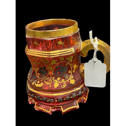 494 - Tankards: 19th cent. Bohemian cranberry and gilt tankards with yellow and white floral decoration, s... 