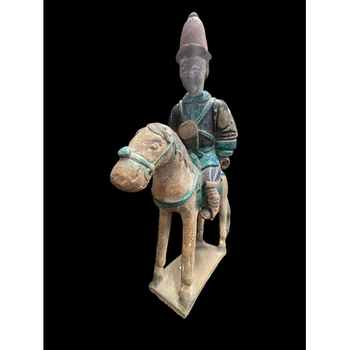 540 - Chinese: Chinese: Ming Period stoneware burial figure in the form of men on horseback in an aubergin... 