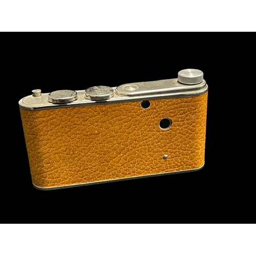 568 - Cameras: Petie Compact miniature camera tan body, single speed shutter, 11/25mm lens 'Leica'. In goo... 